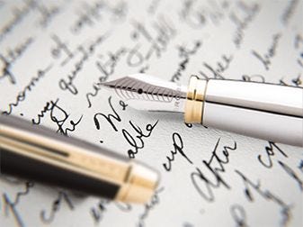 Close up image of script and fountain pen nib.